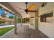 A covered patio with brick pavers, ceiling fan, and a view of the pool and cactus landscaping at 10510 E Terra Dr, Scottsdale, AZ 85258