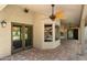 A covered patio with brick pavers, ceiling fan, and view into home and a pool at 10510 E Terra Dr, Scottsdale, AZ 85258