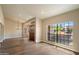 Bright foyer with wood-look floors, decorative front doors, large picture windows, and modern lighting at 10510 E Terra Dr, Scottsdale, AZ 85258