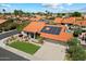 Charming single-story home with solar panels, a well-manicured lawn, and a spacious three-car garage at 10510 E Terra Dr, Scottsdale, AZ 85258