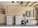 Garage with Tesla power wall units and a collection of storage and electrical units at 10510 E Terra Dr, Scottsdale, AZ 85258
