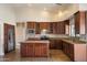Spacious kitchen featuring custom wood cabinets, stainless appliances, and a large island with counter seating at 10510 E Terra Dr, Scottsdale, AZ 85258