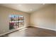 Bright room with wood floors and a large window with a view of the desert landscape at 10510 E Terra Dr, Scottsdale, AZ 85258