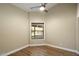 Room with wood floors, a ceiling fan, and a window looking out to the pool area at 10510 E Terra Dr, Scottsdale, AZ 85258