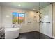 Bathroom with a soaking tub and walk-in shower featuring white and black tile and rainfall showerhead at 10510 E Terra Dr, Scottsdale, AZ 85258