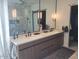 Bathroom featuring double vanity with modern fixtures, soaking tub, and glass shower with marble wall at 10694 E Firethorn Dr, Scottsdale, AZ 85255