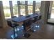 Dining area featuring a modern table with seating for six, complemented by large windows and tile flooring at 10694 E Firethorn Dr, Scottsdale, AZ 85255