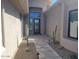 Stylish entrance with desert landscaping, pavers, and dark-framed windows, creating an inviting approach at 10694 E Firethorn Dr, Scottsdale, AZ 85255