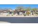 Charming single-story home with desert landscaping, an attached two-car garage, and partial mountain views at 10694 E Firethorn Dr, Scottsdale, AZ 85255