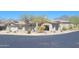 Stunning single-story home featuring a two-car garage, solar panels, desert landscaping, and mountain views at 10694 E Firethorn Dr, Scottsdale, AZ 85255