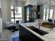 Modern kitchen with stainless appliances, sleek cabinets, and marble countertops, complemented by a stylish wine storage at 10694 E Firethorn Dr, Scottsdale, AZ 85255
