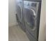 Laundry room features modern, front-load washer and dryer for efficient laundry care at 10694 E Firethorn Dr, Scottsdale, AZ 85255