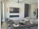 Spacious living room with modern fireplace, large TV, and stylish seating at 10694 E Firethorn Dr, Scottsdale, AZ 85255