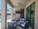 Stylish outdoor living area with comfortable seating, ceiling fan, and pool access at 10694 E Firethorn Dr, Scottsdale, AZ 85255