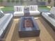 Relaxing patio featuring a modern fire pit and comfortable lounge seating at 10694 E Firethorn Dr, Scottsdale, AZ 85255