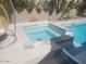 Inviting pool and spa featuring stone accents and desert landscaping at 10694 E Firethorn Dr, Scottsdale, AZ 85255
