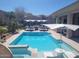 Inviting pool and patio area perfect for outdoor entertaining, featuring comfortable seating and a spa at 10694 E Firethorn Dr, Scottsdale, AZ 85255