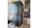 Elegant glass-enclosed wine cellar showcasing extensive storage and a stylish bar area with modern finishes at 10694 E Firethorn Dr, Scottsdale, AZ 85255