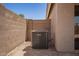HVAC system located on the side of the house, surrounded by a decorative brick wall at 11004 E Delta Ave, Mesa, AZ 85208