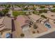 Expansive aerial view showcases the home's desert landscaping, tile roof, and proximity to the neighborhood park at 11004 E Delta Ave, Mesa, AZ 85208