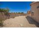 Low maintenance backyard with rock landscaping, enclosed by a tall privacy wall at 11004 E Delta Ave, Mesa, AZ 85208