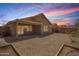 Backyard view featuring a covered patio and low-maintenance desert landscaping, perfect for outdoor living and entertaining at 11004 E Delta Ave, Mesa, AZ 85208