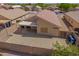 Aerial view of the property's backyard featuring a covered patio and a fenced-in yard at 11004 E Delta Ave, Mesa, AZ 85208