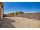Fully fenced backyard featuring desert landscaping, rock, and a retaining wall at 11004 E Delta Ave, Mesa, AZ 85208