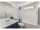 Bright bathroom features a tiled tub, shower, and modern vanity at 11004 E Delta Ave, Mesa, AZ 85208