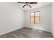 Bright bedroom with a window and wood-look flooring at 11004 E Delta Ave, Mesa, AZ 85208