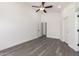 Bright bedroom features a ceiling fan and durable wood-look flooring at 11004 E Delta Ave, Mesa, AZ 85208