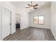 Bright bedroom with hardwood flooring, ceiling fan and attached bathroom at 11004 E Delta Ave, Mesa, AZ 85208