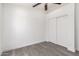 Bedroom with sliding closet doors and durable wood-look flooring at 11004 E Delta Ave, Mesa, AZ 85208