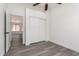 Spacious bedroom featuring sliding closet doors and wood-look flooring at 11004 E Delta Ave, Mesa, AZ 85208