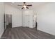 Bright bedroom with modern ceiling fan and multiple entry doors at 11004 E Delta Ave, Mesa, AZ 85208