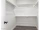 Walk-in closet with multiple rows of shelving and wood-look flooring at 11004 E Delta Ave, Mesa, AZ 85208