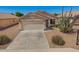 Beautiful single-story home boasts desert landscaping, tile roof, and a two-car garage at 11004 E Delta Ave, Mesa, AZ 85208