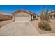 Charming single-story home with a two-car garage, desert landscaping, and barrel cactus at 11004 E Delta Ave, Mesa, AZ 85208