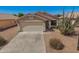 Single-story home with desert landscaping, tile roof, and a spacious two-car garage at 11004 E Delta Ave, Mesa, AZ 85208