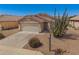 Charming single-story home boasts desert landscaping, tile roof, and a two-car garage at 11004 E Delta Ave, Mesa, AZ 85208