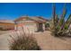 Single-story home with a two-car garage, barrel cactus, and desert landscaping at 11004 E Delta Ave, Mesa, AZ 85208