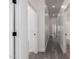Hallway features recessed lighting, neutral walls and gray flooring. Doors to rooms off of the hallway at 11004 E Delta Ave, Mesa, AZ 85208