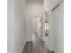 Hallway with gray flooring, neutral paint and a view of another room in the home at 11004 E Delta Ave, Mesa, AZ 85208