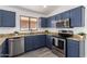 Modern kitchen featuring stainless steel appliances, granite countertops, and abundant cabinetry at 11004 E Delta Ave, Mesa, AZ 85208