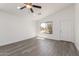 Bright, open living room featuring gray wood flooring and a modern ceiling fan at 11004 E Delta Ave, Mesa, AZ 85208