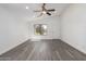 Inviting living room featuring gray wood floors, natural light, and a neutral color palette at 11004 E Delta Ave, Mesa, AZ 85208