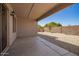 Covered patio leads to a backyard space that is surrounded by a tall brick wall at 11004 E Delta Ave, Mesa, AZ 85208