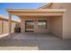 View of the covered patio with access to the house through sliding glass doors and a low maintenance yard at 11004 E Delta Ave, Mesa, AZ 85208