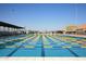A large swimming pool featuring multiple lanes and starting blocks for competitive swimming, and a modern aquatic center at 11004 E Delta Ave, Mesa, AZ 85208