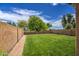 Well-maintained backyard featuring a large green lawn, gravel border, and block fence at 11301 W Glenrosa Ave, Phoenix, AZ 85037